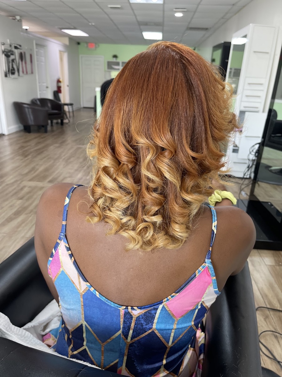 Glossy caramel-blonde curls styled into bouncy waves