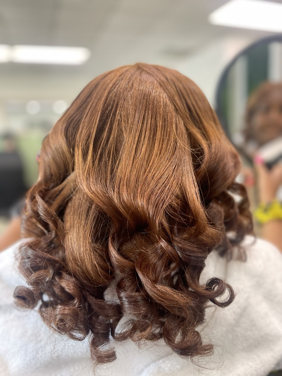 Voluminous auburn curls after a Dominican blowout at Rosy Dominican Hair Spa in Stockbridge, GA