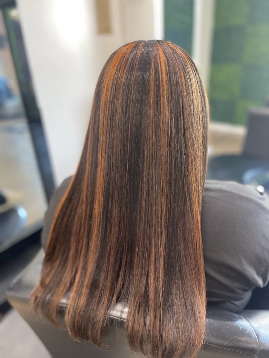 Sleek, shiny copper-highlighted blowout